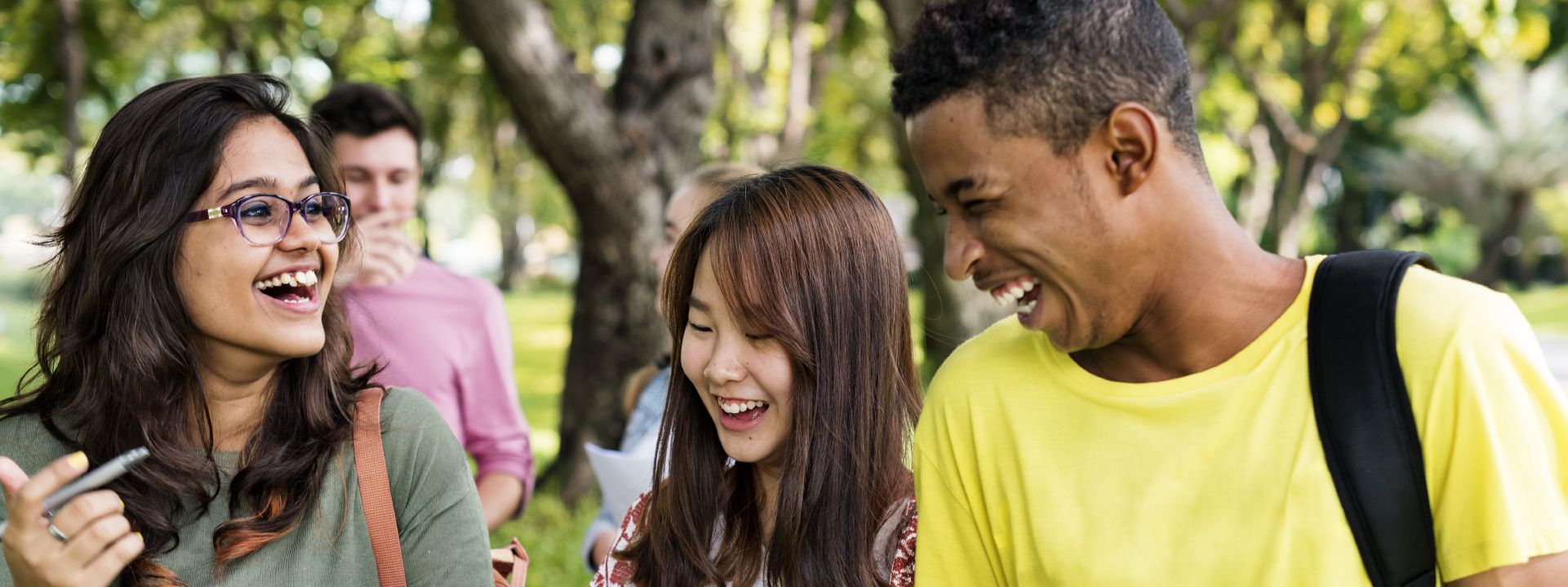 A diverse group of young people laughing.