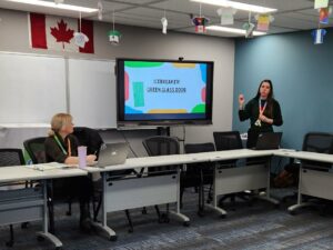 Woman leads group of people through an ice breaker game.
